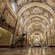 The Nave of Saint John's Co Cathedral, with the walls and ceiling covered in ornate paintings and tapestries